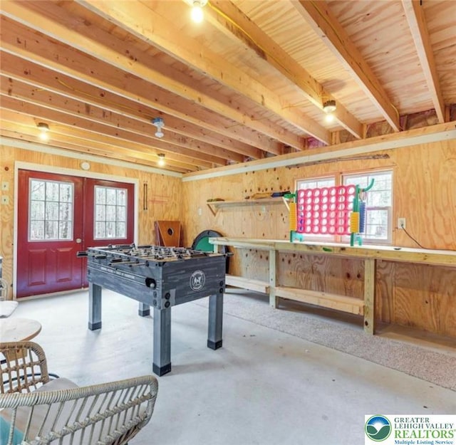 266 Maxatawny Dr, Coolbaugh Twp, PA 18347 - recreation room with healthy amount of natural light, french doors, concrete flooring, and wood walls