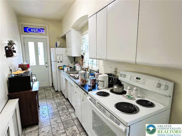 520 2nd St, Catasauqua Borough, PA 18032 - kitchen with white appliances, healthy amount of natural light, and white cabinets