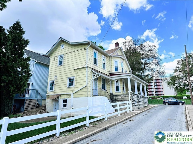 520 2nd St, Catasauqua Borough, PA 18032 - view of side of property featuring a fenced front yard, a chimney, and covered porch