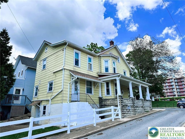 520 2nd St, Catasauqua Borough, PA 18032 - view of front of home featuring a chimney, a fenced front yard, and a porch