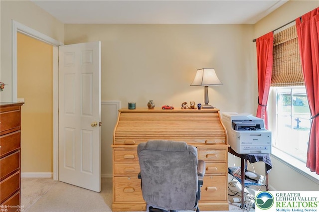 home office featuring light colored carpet and baseboards