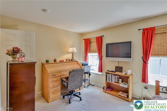 carpeted home office featuring baseboards