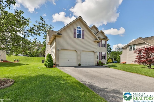 traditional-style home featuring an attached garage, asphalt driveway, and a front yard