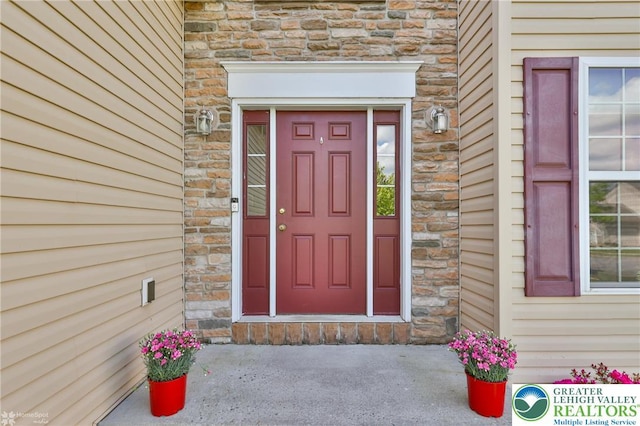 doorway to property with stone siding