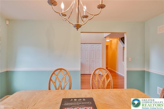 dining area featuring a chandelier and wood finished floors