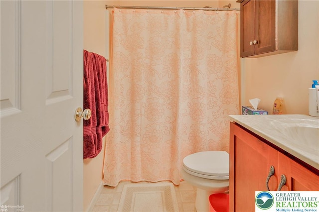 full bath featuring toilet, vanity, a shower with shower curtain, and tile patterned floors
