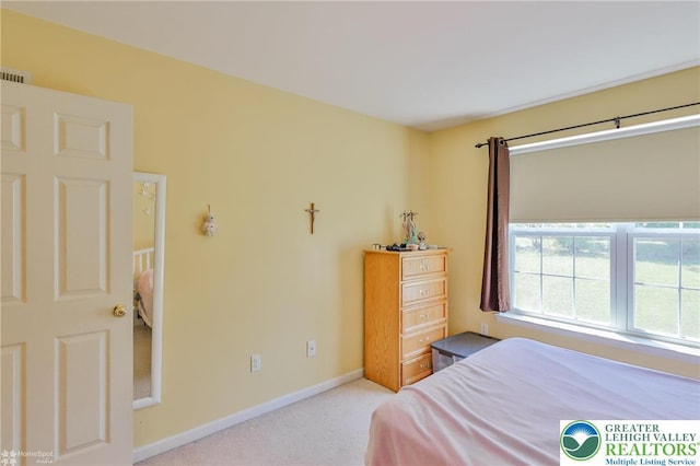 carpeted bedroom with baseboards