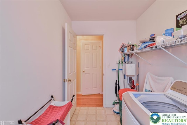 washroom with washer / dryer and light floors