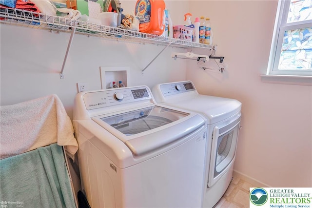 laundry room featuring washer and dryer and baseboards