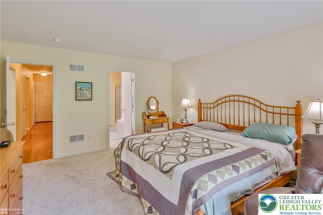 bedroom with carpet, baseboards, and ensuite bath