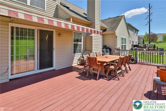 wooden deck with outdoor dining space