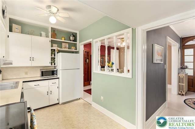 kitchen featuring freestanding refrigerator, stainless steel microwave, open shelves, ceiling fan, and white cabinets