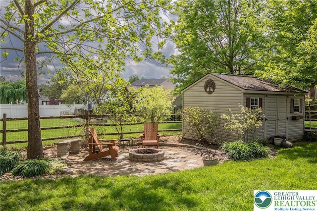 view of yard featuring an outdoor fire pit, a storage shed, and an outdoor structure