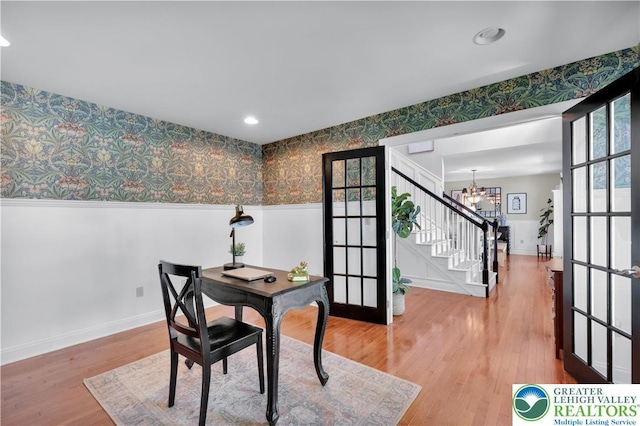 home office featuring wallpapered walls, french doors, a chandelier, a wainscoted wall, and baseboards