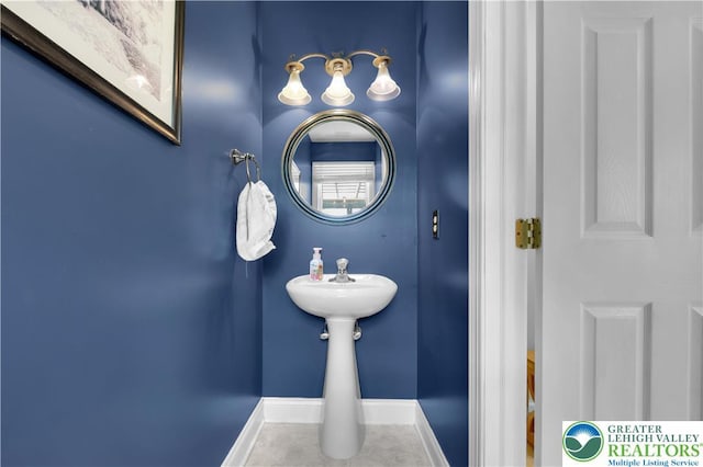 bathroom with baseboards and tile patterned floors