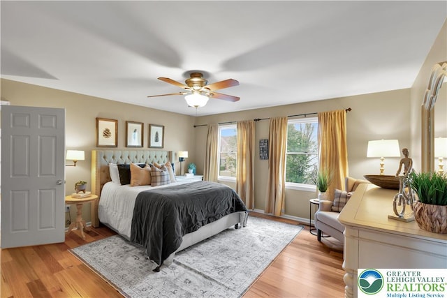 bedroom with light wood-style floors and a ceiling fan