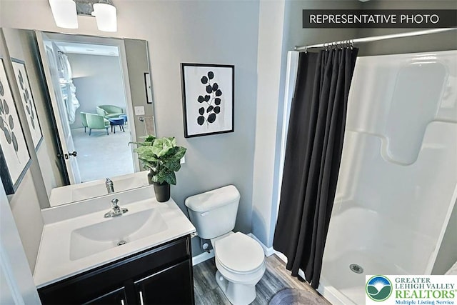 3280 Tepes Dr Unit 152, Allen Twp, PA 18067 - full bathroom featuring a stall shower, toilet, baseboards, and vanity