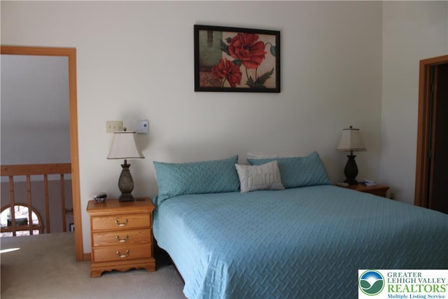 bedroom featuring light carpet