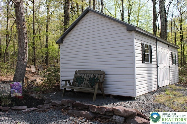 view of home's exterior with an outbuilding