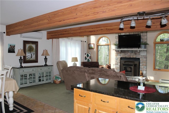 kitchen with open floor plan, tile patterned floors, a wall mounted AC, plenty of natural light, and beamed ceiling