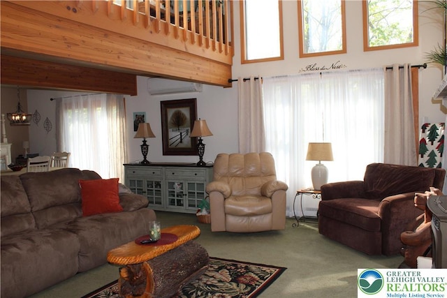 carpeted living room with a chandelier, a wall mounted AC, and a towering ceiling