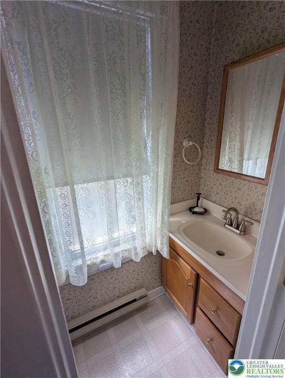 bathroom featuring a baseboard heating unit, wallpapered walls, vanity, and tile patterned floors