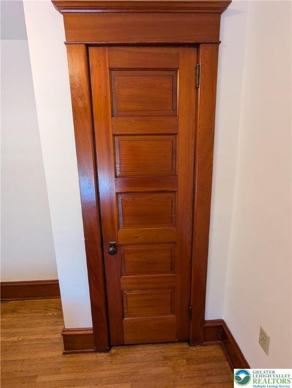 detailed view of baseboards and wood finished floors