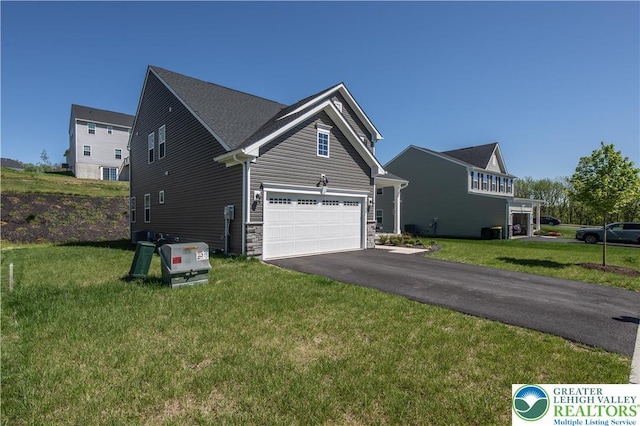 8202 Young Blvd, Upper Macungie Twp, PA 18051 - view of front of house featuring asphalt driveway, a front lawn, and stone siding