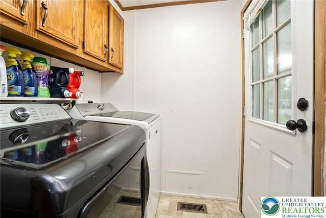 washroom with cabinet space and washing machine and dryer