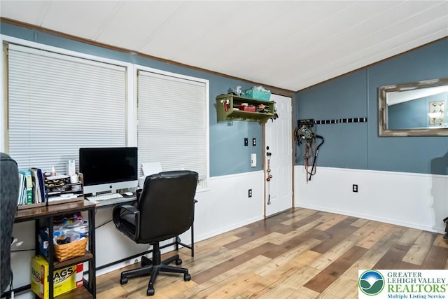 office featuring lofted ceiling and wood finished floors