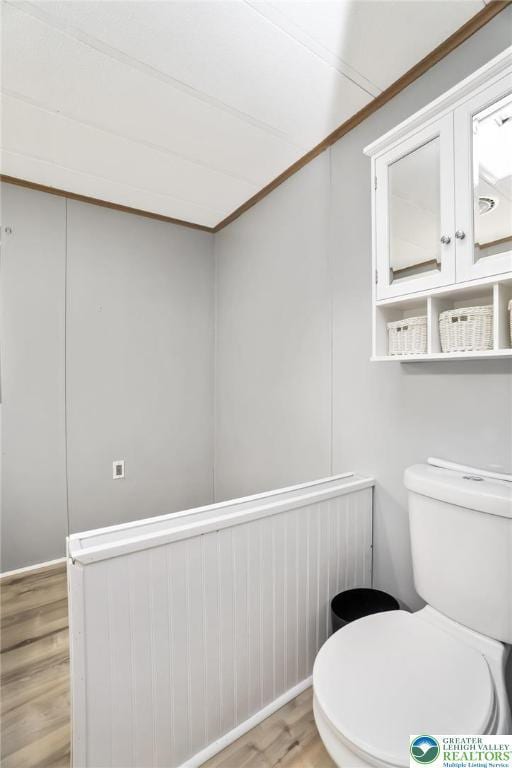 bathroom featuring wood finished floors and toilet
