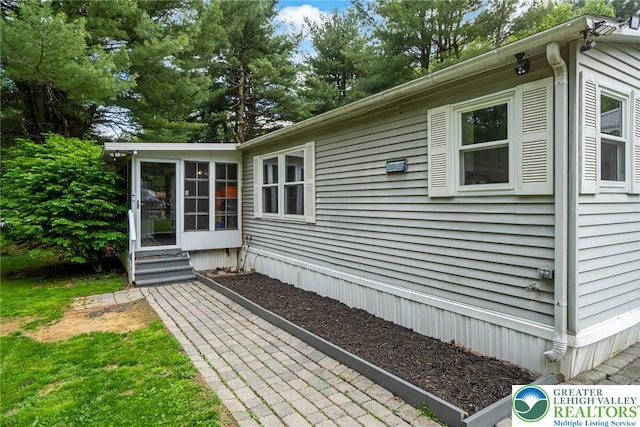 view of home's exterior with a sunroom