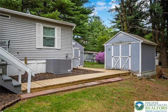 view of yard featuring cooling unit, a storage shed, and an outdoor structure