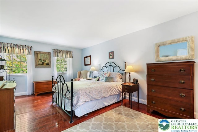 bedroom with wood finished floors and baseboards