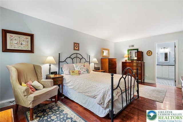bedroom featuring wood finished floors and baseboards