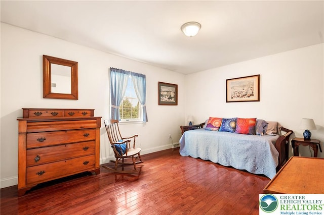 bedroom with hardwood / wood-style flooring and baseboards