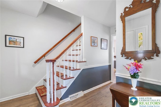 staircase with wood finished floors