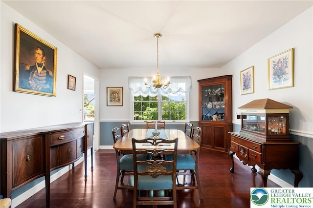 dining area with a chandelier and dark wood-style floors