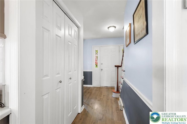 hallway with wood finished floors and baseboards