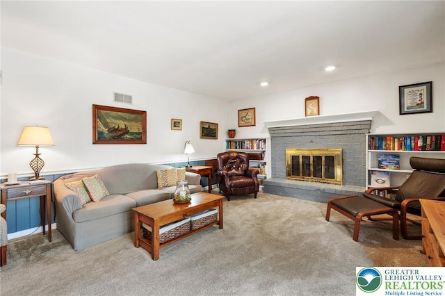 carpeted living room featuring a fireplace and recessed lighting