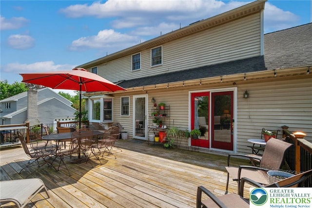 wooden deck with outdoor dining space