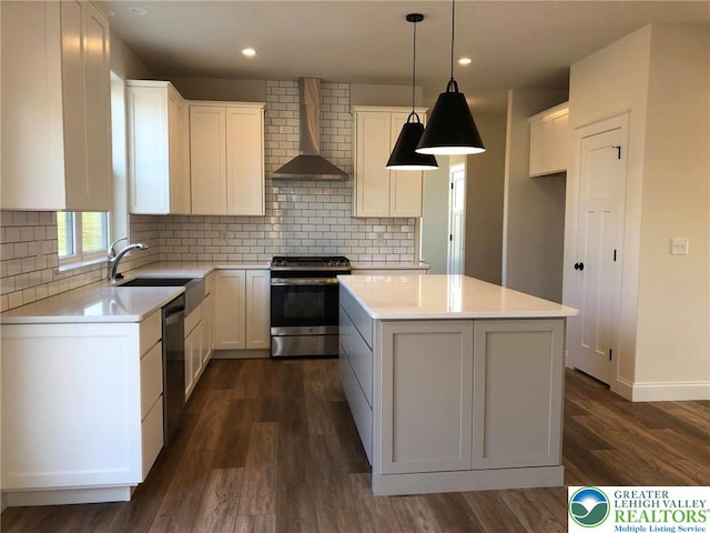 65 Island Ct, Williams Twp, PA 18042 - kitchen with stainless steel appliances, wall chimney exhaust hood, a sink, dark wood-style flooring, and a kitchen island