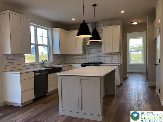 65 Island Ct, Williams Twp, PA 18042 - kitchen featuring dishwasher, wall chimney range hood, light countertops, a sink, and a center island