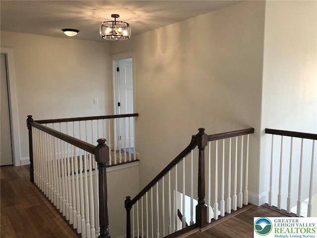 65 Island Ct, Williams Twp, PA 18042 - stairs featuring wood finished floors, a chandelier, and baseboards