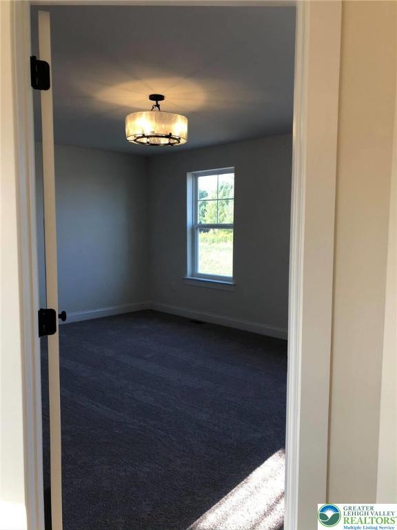65 Island Ct, Williams Twp, PA 18042 - spare room featuring dark carpet and baseboards