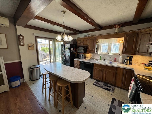 kitchen featuring black appliances, light countertops, a chandelier, a sink, and beam ceiling