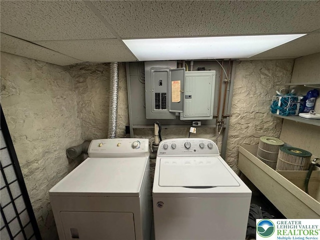 washroom featuring washing machine and dryer and electric panel