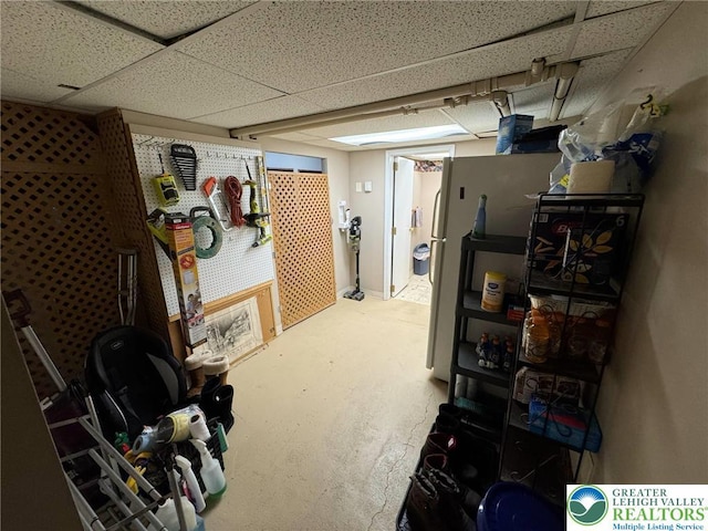 finished below grade area featuring a drop ceiling