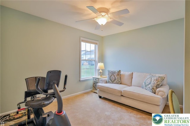 carpeted office with baseboards and a ceiling fan