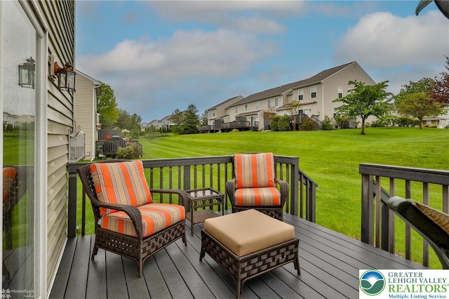 deck with a residential view and a lawn